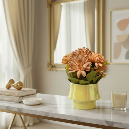Decorative setup on a marble table with a vase of flowers, books, and a glass.