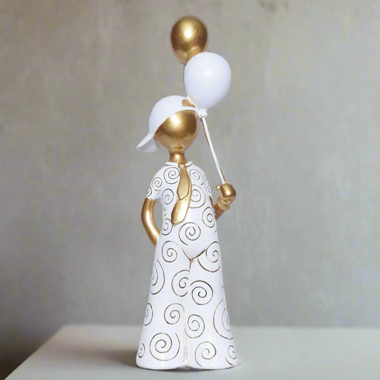 Decorative figurine of a woman holding balloons against a plain background