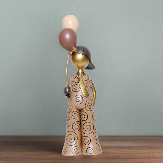 Decorative figurine of a person with balloons against a plain background