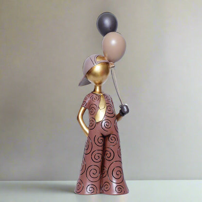Decorative figurine of a person holding balloons against a white background