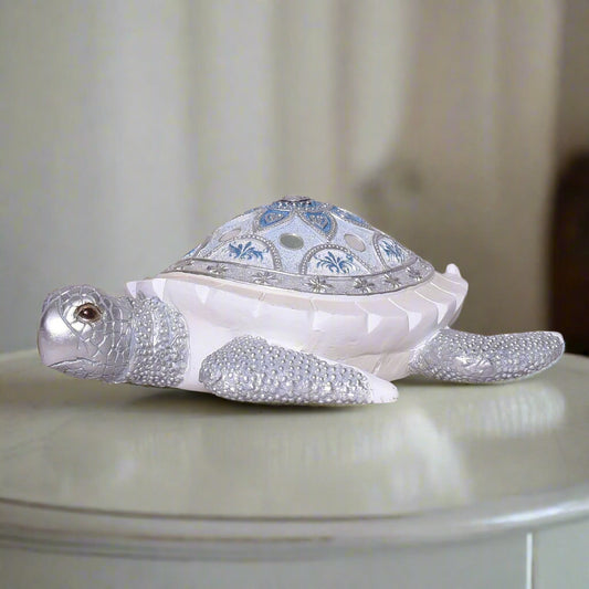 Decorative turtle figurine with intricate design on a neutral background