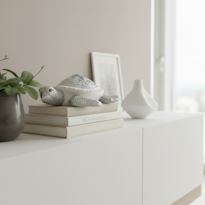Decorative items including a vase, books, and decorative stones on a white surface.