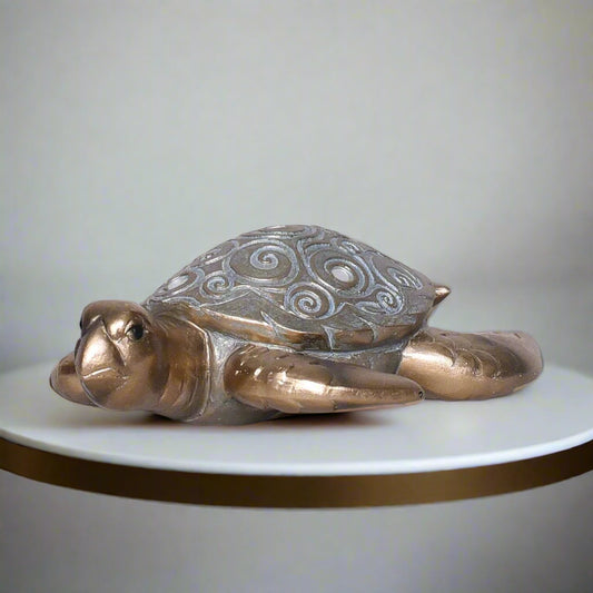 Decorative turtle figurine with intricate patterns on a light gray background