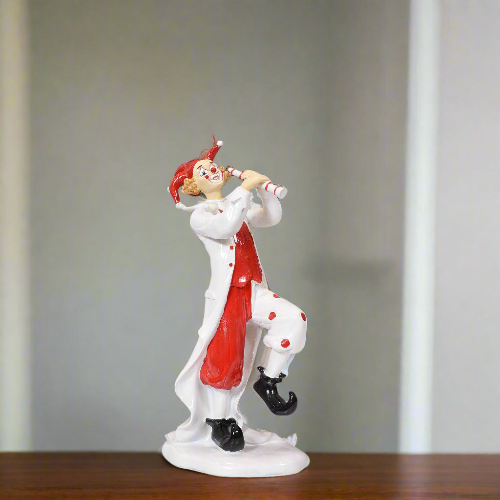 Clown figurine with red and white outfit on a gray background