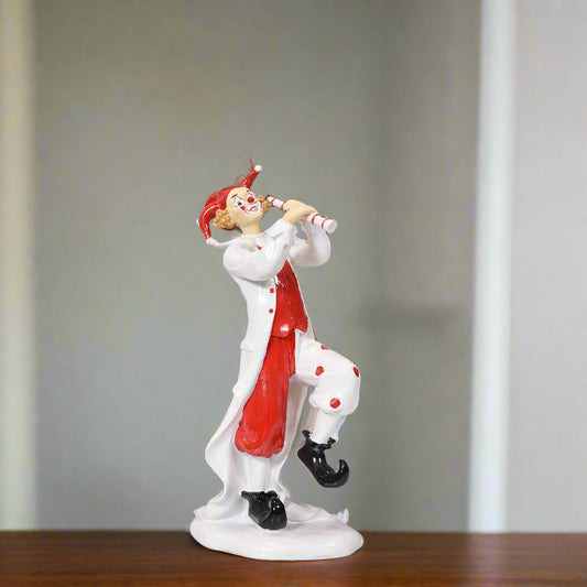 Clown figurine with red and white outfit on a gray background