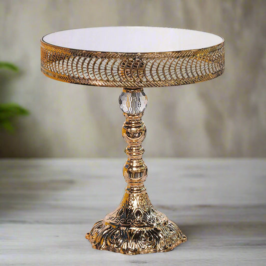 Decorative gold table with intricate design on a white background