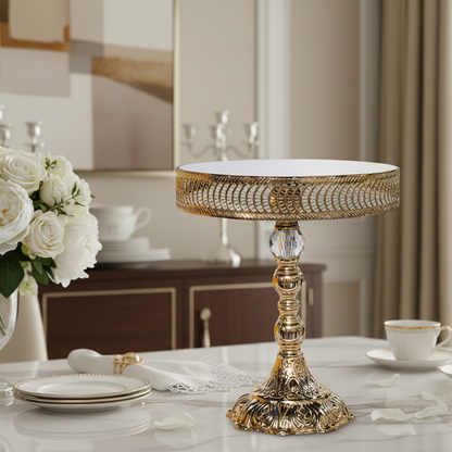 Decorative gold table lamp on a table with white flowers and tea set in a room.