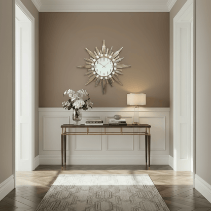 Decorative wall clock with gold sunburst design on a white background