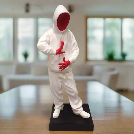 Statue of a person in a white outfit with red gloves and face in an indoor setting