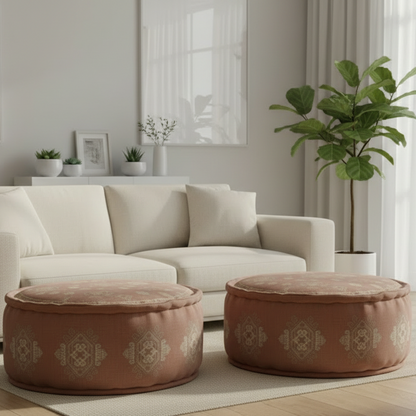 Beige sofa with two patterned ottomans in a living room setting.
