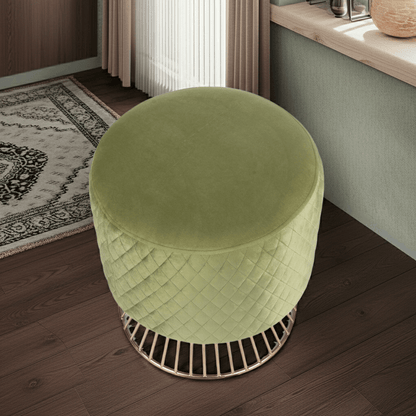 Green ottoman with woven pattern on a wooden floor