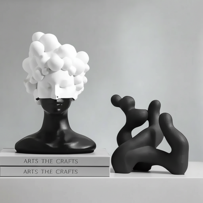 Black and white abstract sculptures on a gray surface with 'ARTS THE CRAFTS' books.