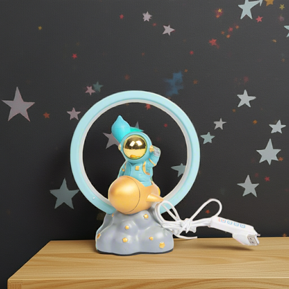 Children's lamp with an astronaut design on a wooden surface against a starry background
