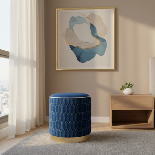 Blue ottoman in a room with abstract art and a wooden side table.