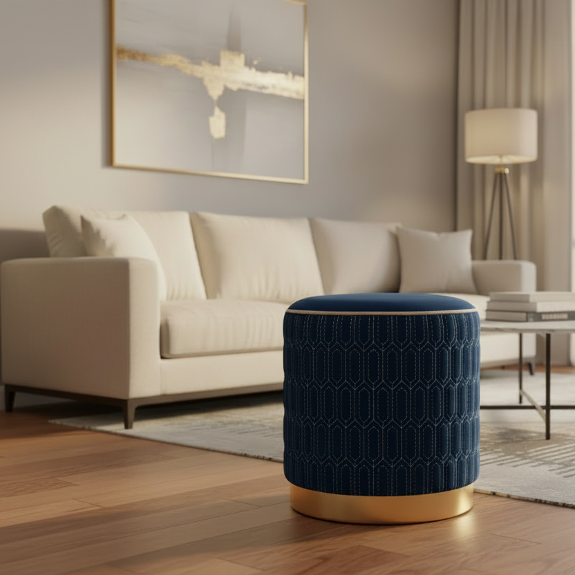 Navy blue ottoman with gold base in a living room setting