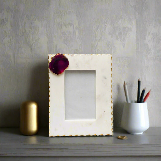 Marble picture frame with gold accents on a white background