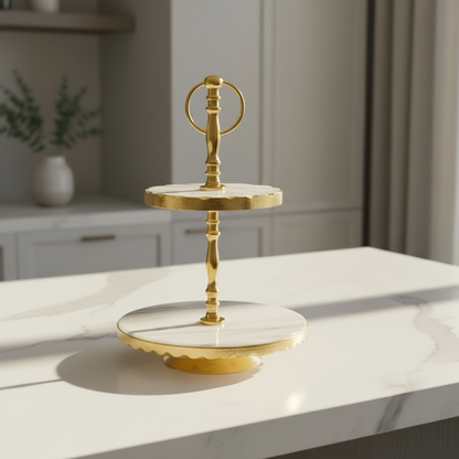 Gold cake stand on a white countertop with a kitchen background