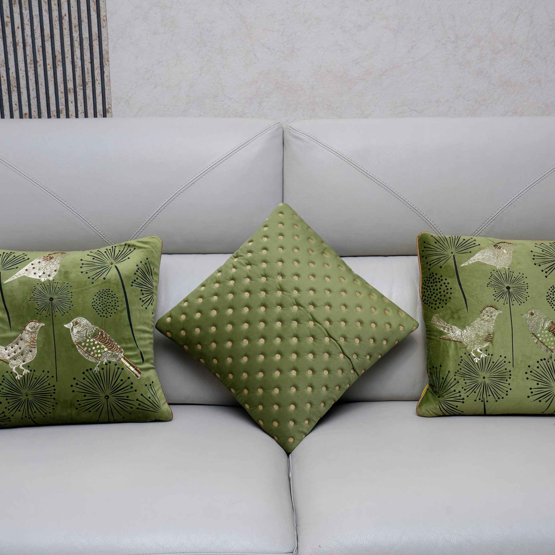 Green patterned cushions on a light gray sofa