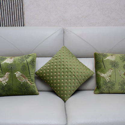 Green patterned cushions on a light gray sofa