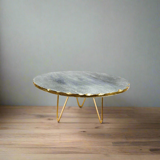 Marble coffee table with gold base on a white background