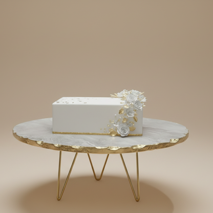 Decorative cake with white flowers on a round gold table against a beige background