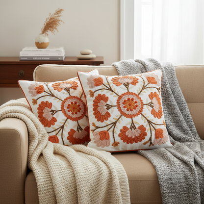 Decorative pillows with floral patterns on a couch in a cozy living room.