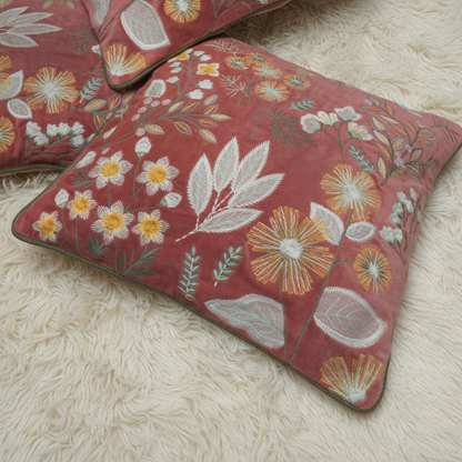 Floral embroidered cushions on a textured surface