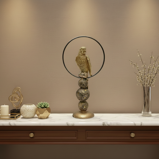 Decorative object with a bird figure on a spherical base against a white background