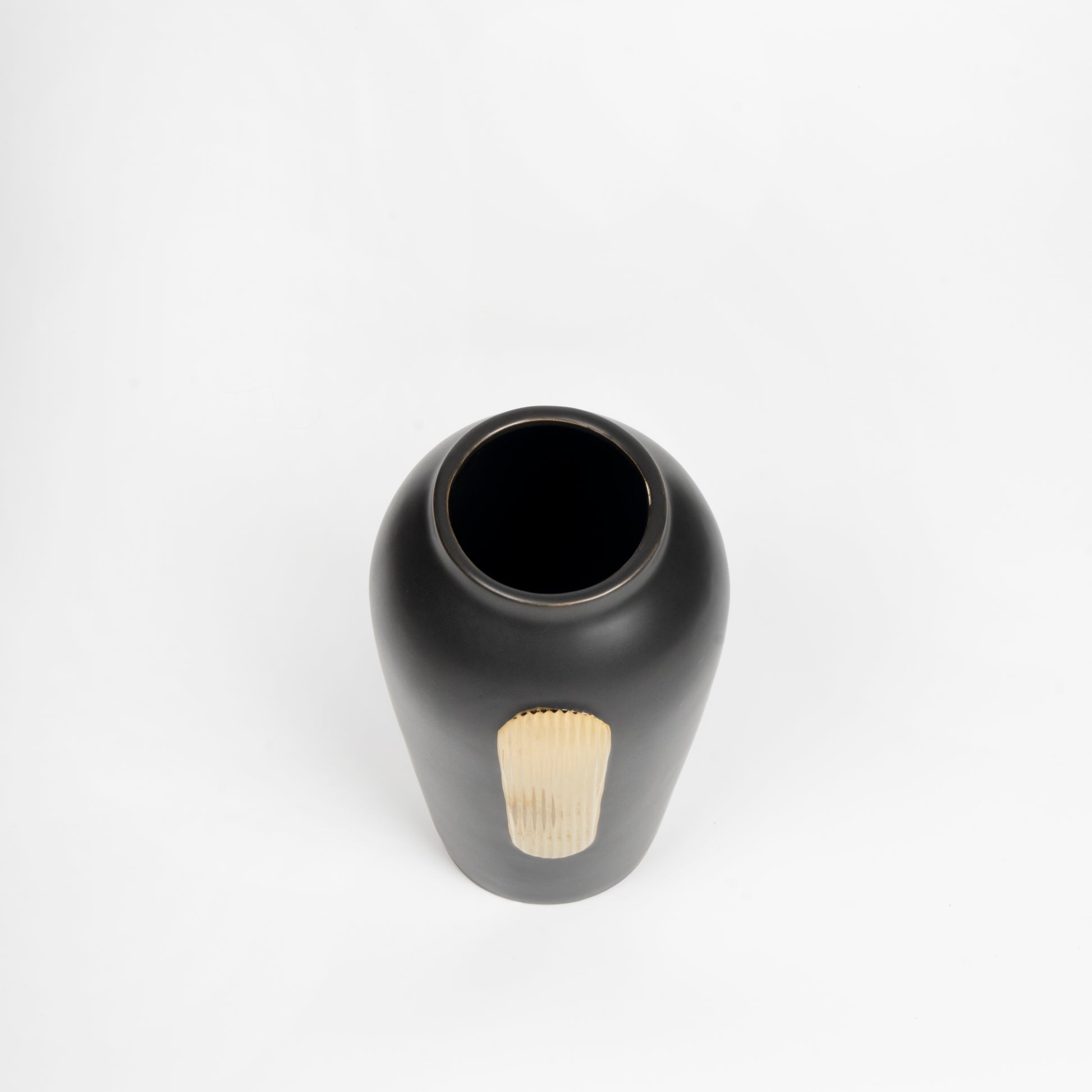 Black ceramic vase with a textured base on a white background