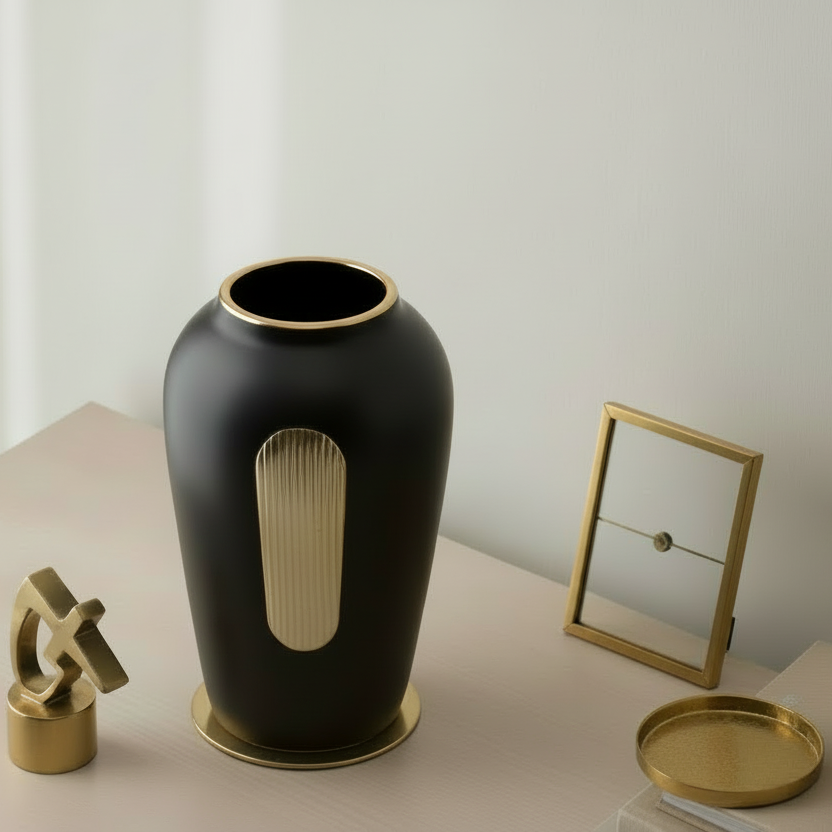 Black vase with a unique design on a wooden surface