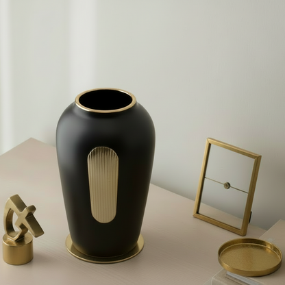 Black vase with a unique design on a wooden surface