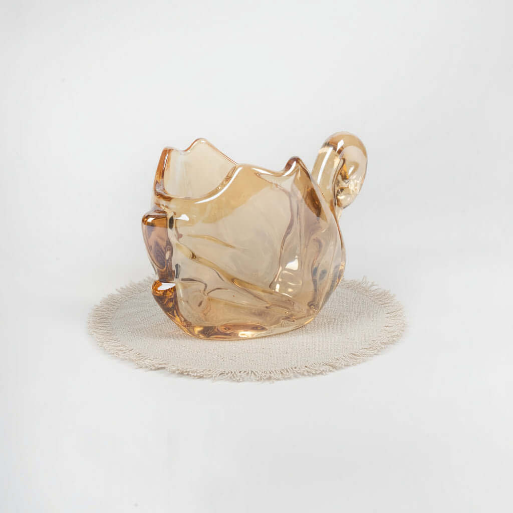 Glass cat-shaped object on a white background