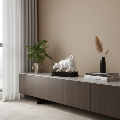 Modern interior with a sideboard displaying decor items including a plant, sculpture, and books.