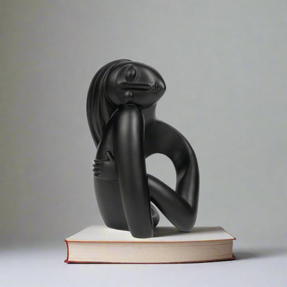 Black abstract sculpture on a white background