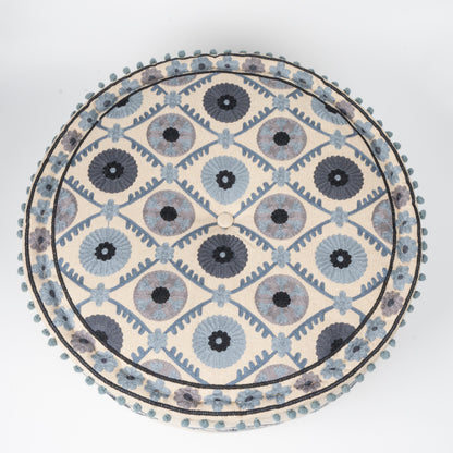 Round decorative mat with blue and gray floral pattern on a white background