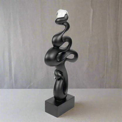 Black abstract sculpture on a white background