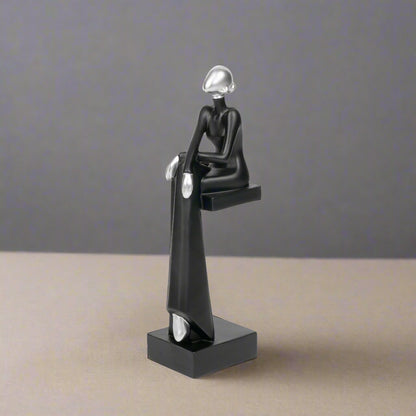 Black and silver abstract sculpture on a white background