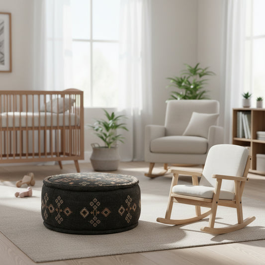 Round gray fabric ottoman with decorative patterns on a white background