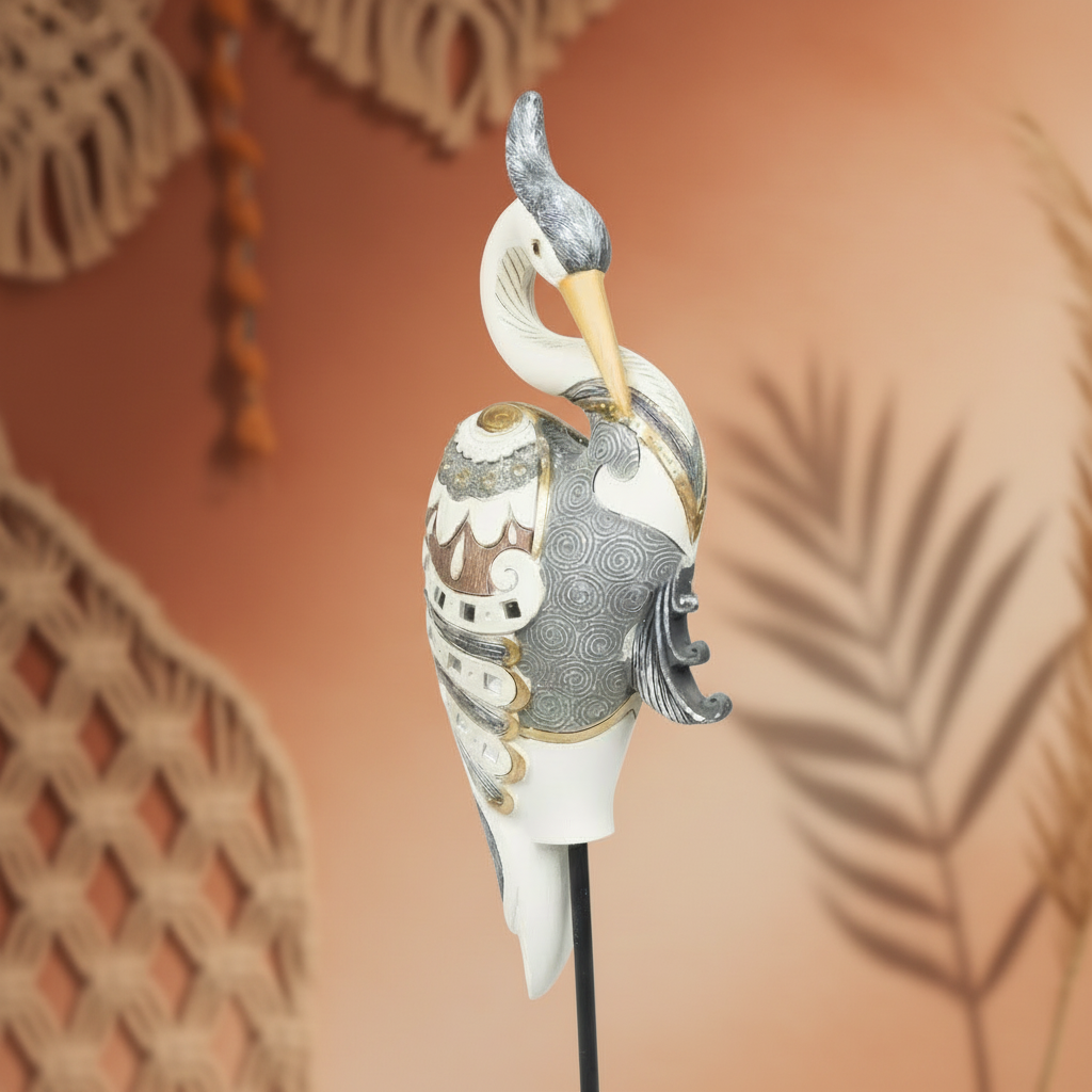 Decorative heron sculpture with intricate patterns on a blurred background