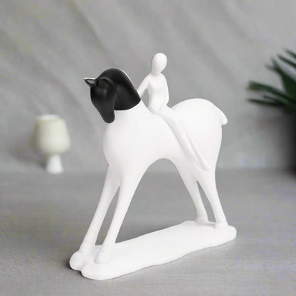 White and black ceramic figurine of a couple on a white background