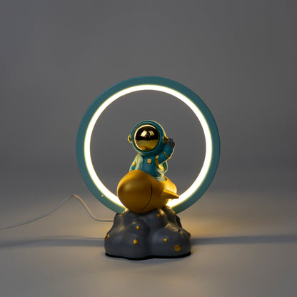 Decorative lamp with an astronaut figure on a cloud and a neon ring light.
