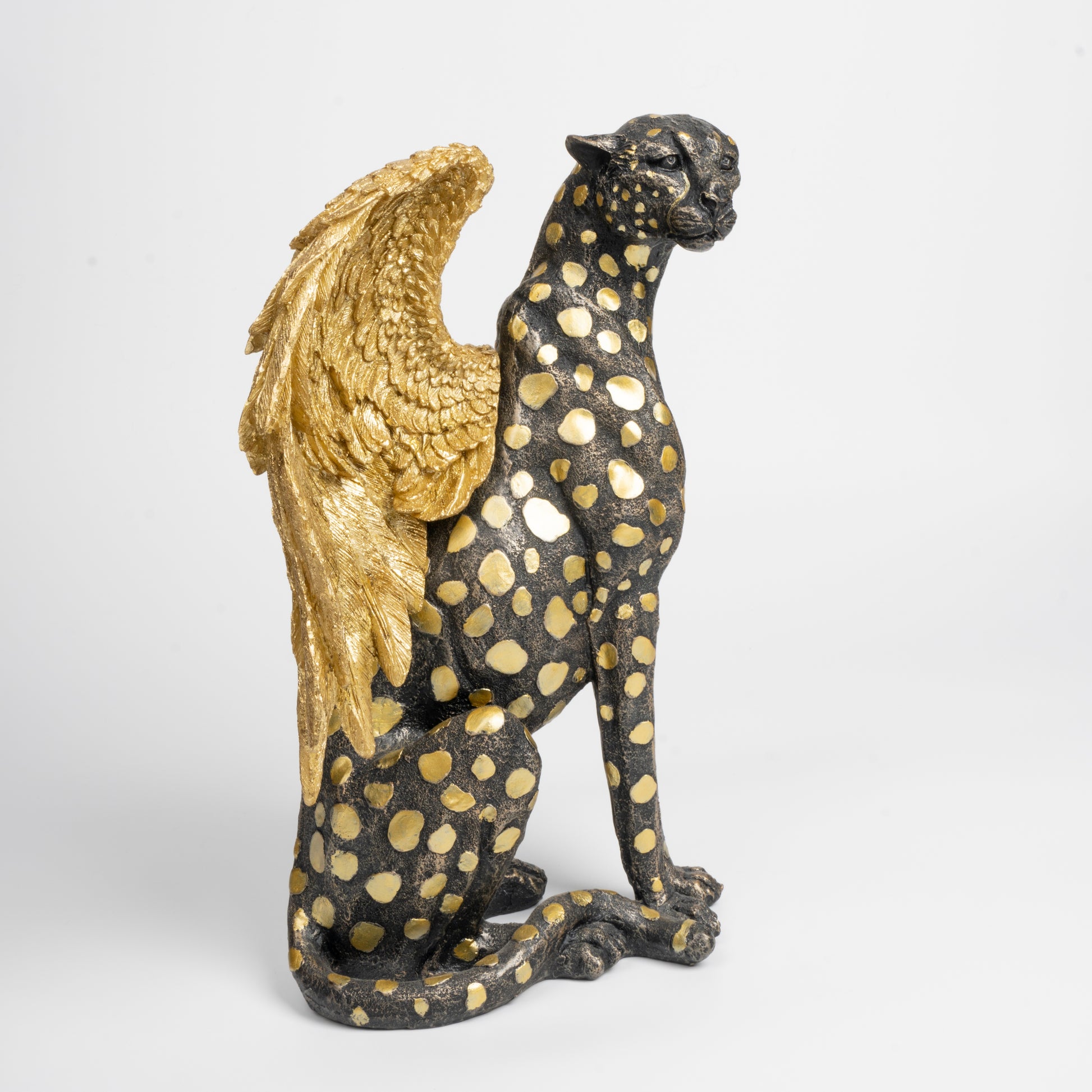 Statue of a panther with gold wings on a white background