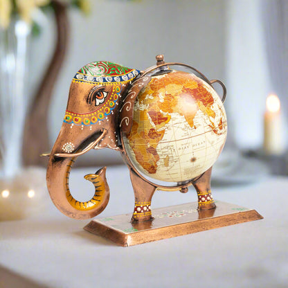 Decorative elephant figurine holding a world globe on a white background