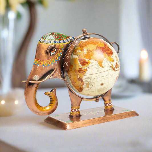 Decorative elephant figurine holding a world globe on a white background