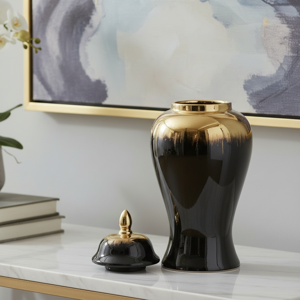 Black and gold decorative urns on a marble surface with abstract art in the background