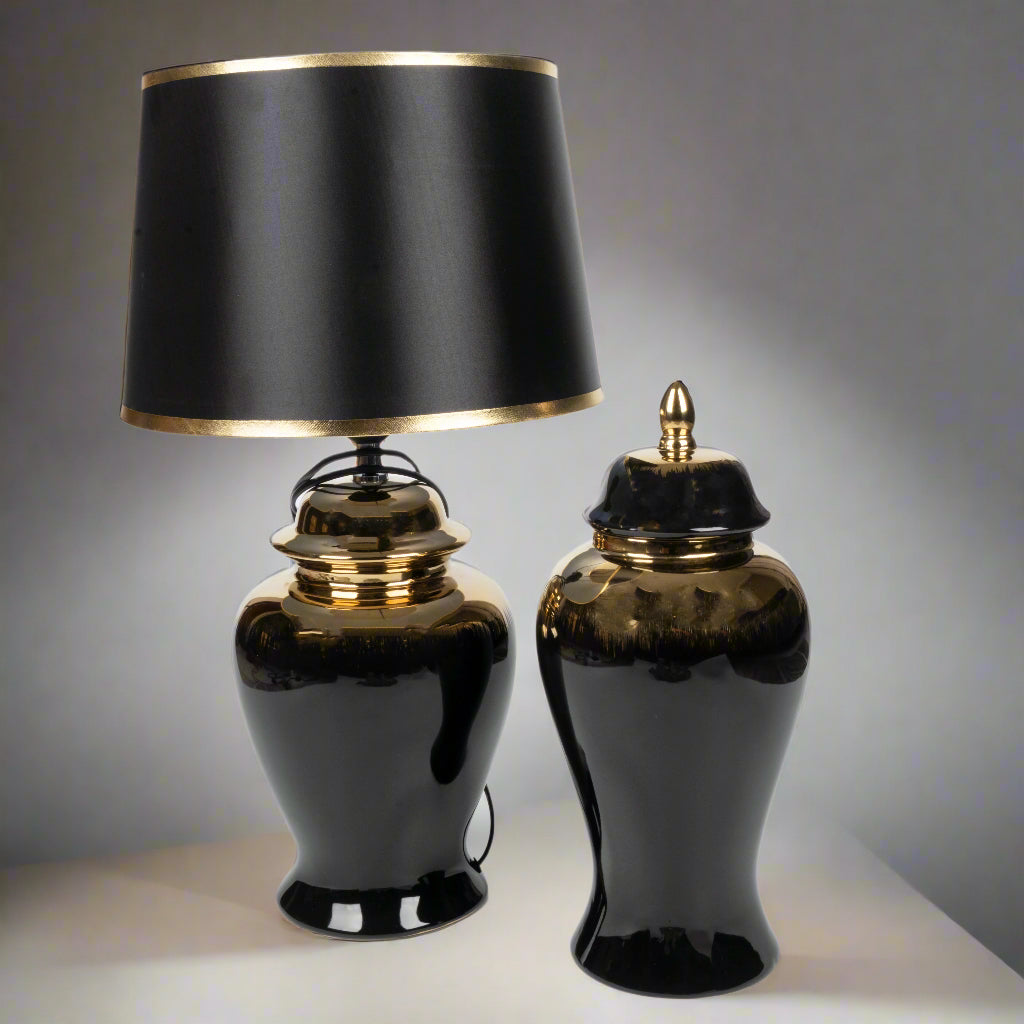 Two black table lamps with gold accents on a neutral background