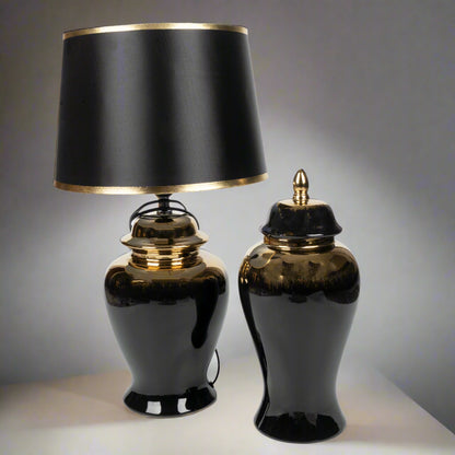 Two black table lamps with gold accents on a neutral background