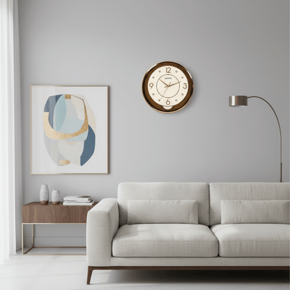 Wall clock with gold frame and white face on a light gray background