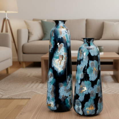 Two decorative vases with blue and black patterns on a wooden floor in a living room.