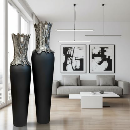 Modern living room with two large black vases and abstract art on the wall.